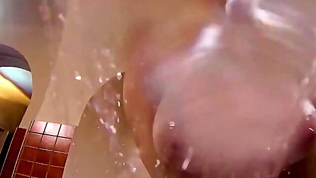 Voluptuous brunette with massive tits, Karina Hart is making an erotic video in the bathroom
