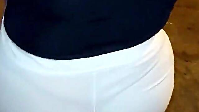 Aged woman wearing red thread in transparent leggings, captured on the street