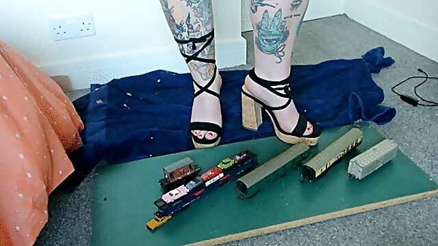 Giantess Jayne crushes some train coaches and small cars in chunky heels toy car crush left view