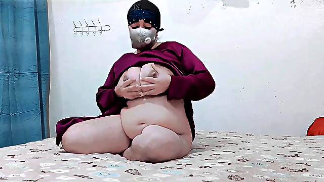 Niqab-wearing girl pleasures herself showcasing her ample natural assets
